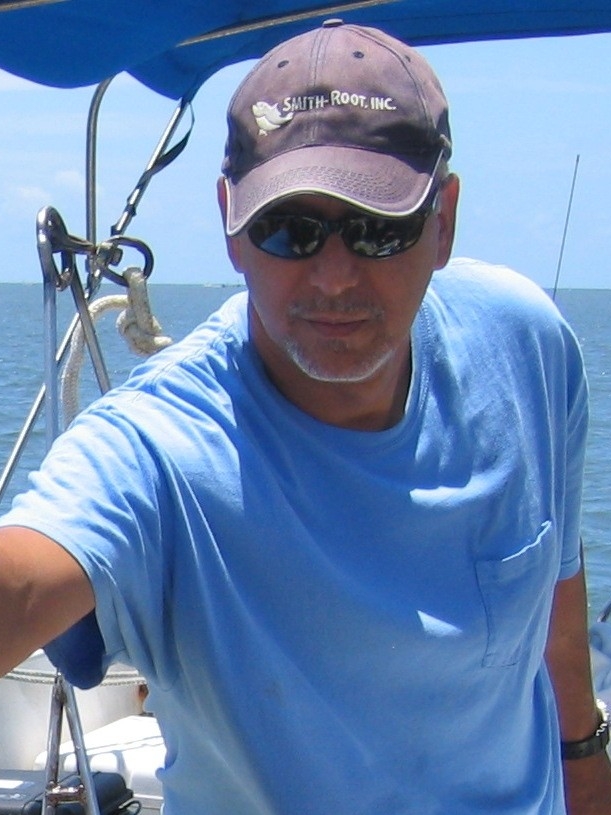 Dr. Charles Acosta at sea on a boat during research.