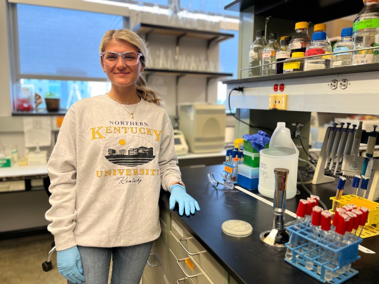NKU Chemistry major in the lab smiling for the camera.