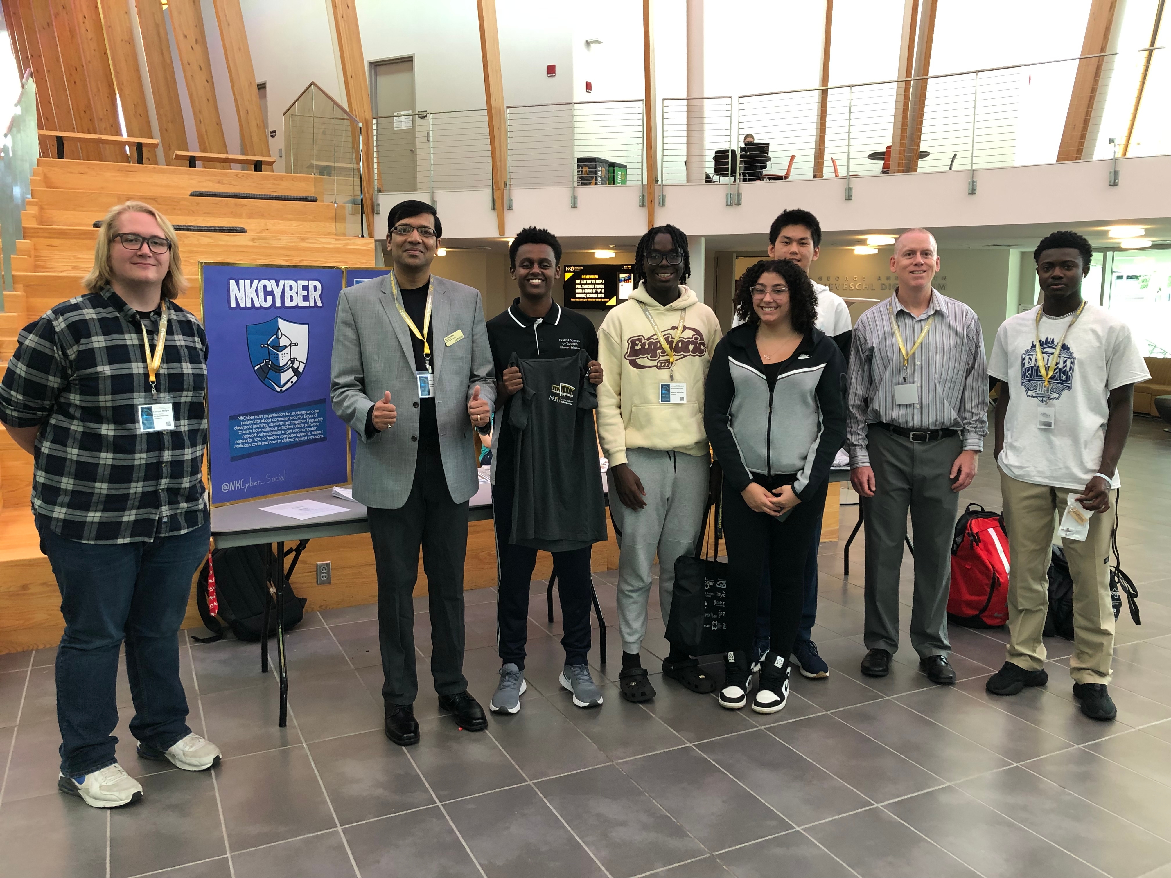 High school students standing with their prizes won along with NKU club members and faculty