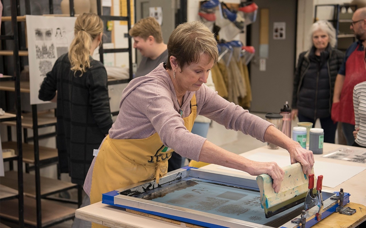 Adult learner working in art workroom