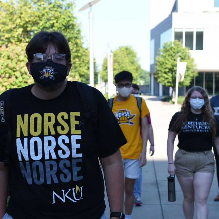Students wearing masks on NKU campus walking.