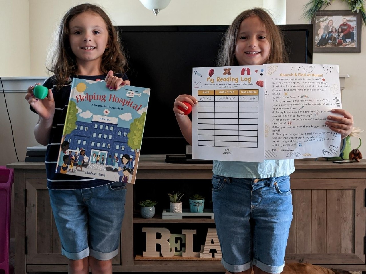 Middle school students holding books and activity sheets