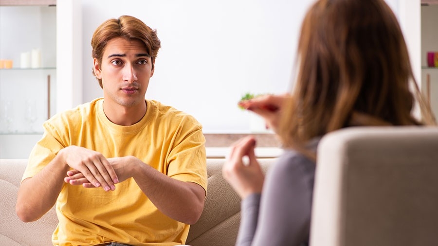 Two people communicating using ASL