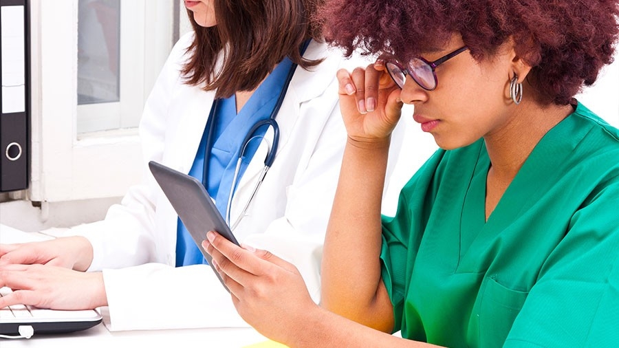 Researchers examine data on a tablet
