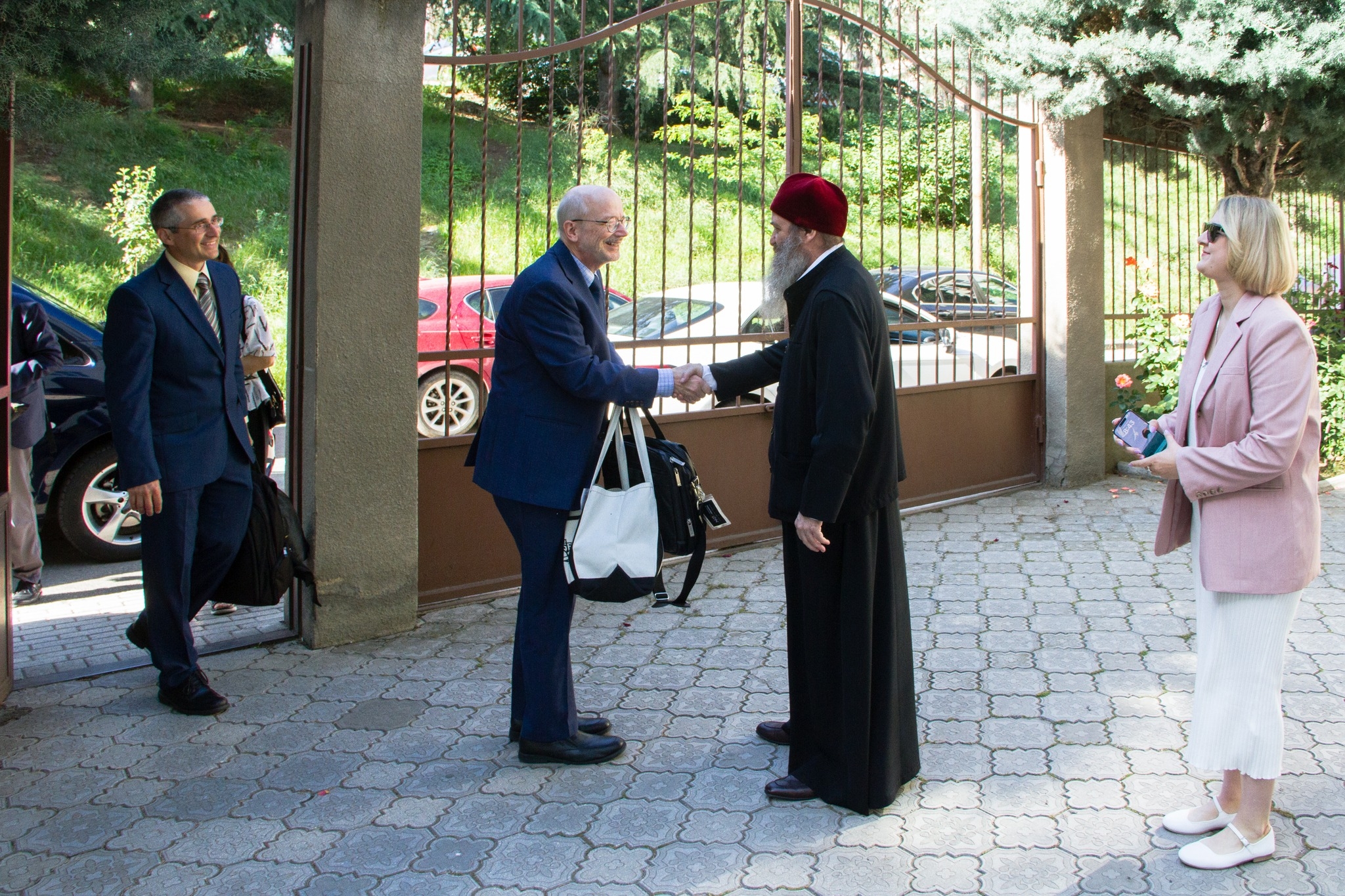 Dr. Kevin Kirby, Dean of NKU's College of Informatics, shakes hands with St. Andrews Georgian University's Archbishop Iakob. 